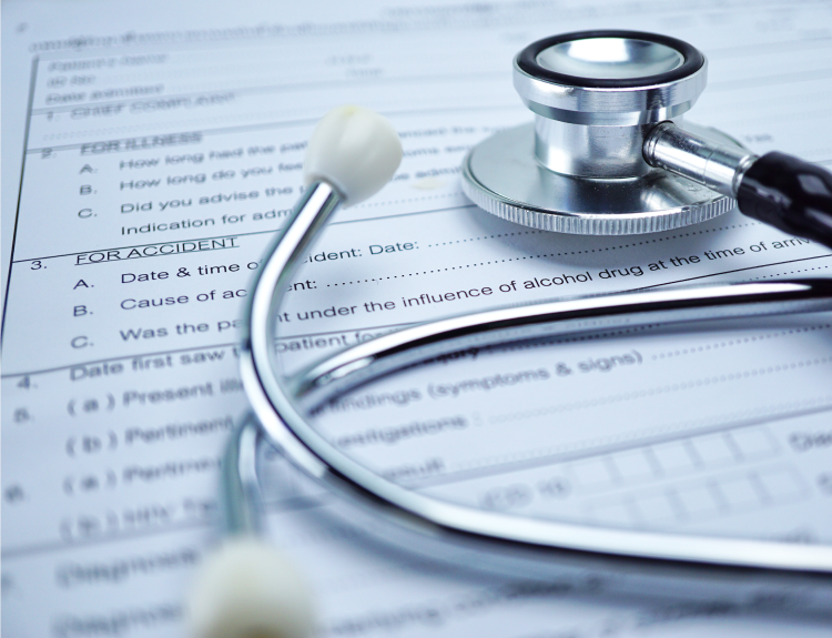 Stethoscope on an insurance claim form for a catastrophic injury case