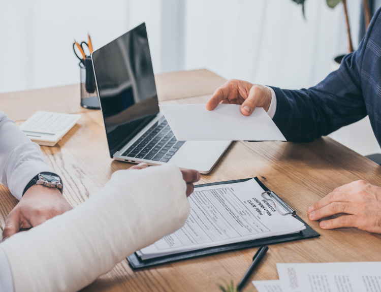 Miami catastrophic injury lawyer reviewing case documents with a client