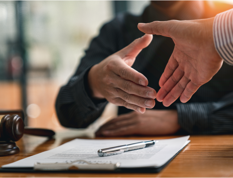Client and Miami catastrophic injury lawyer shaking hands after a case consultation